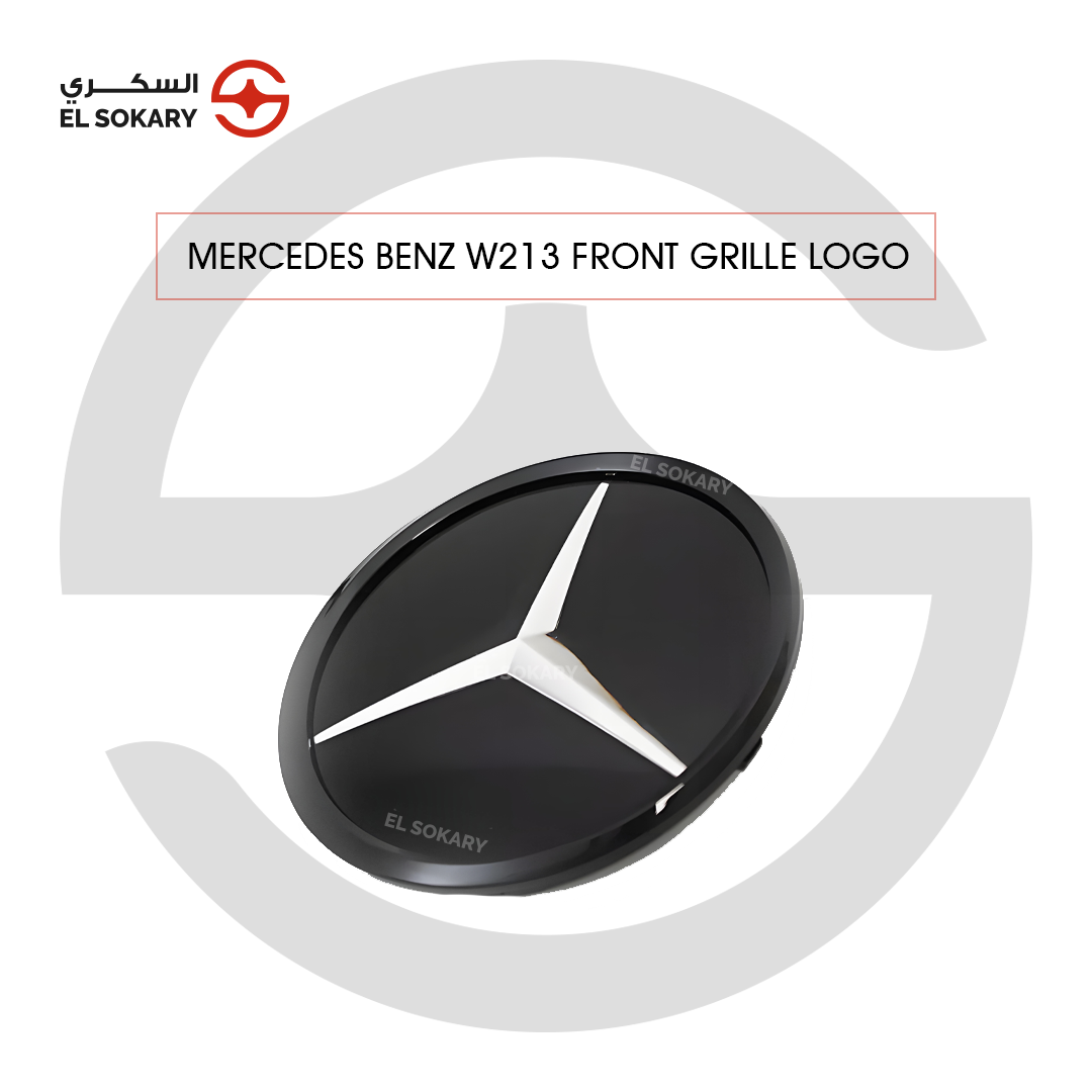 Front view of a Mercedes-Benz W213 E-Class grill emblem featuring a smooth glass-like black surface with a central white three-pointed star logo.